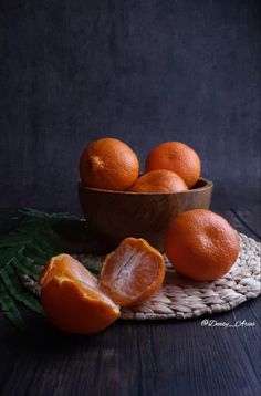 some oranges are sitting in a bowl on a table