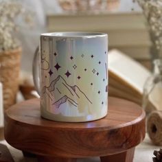 a coffee mug sitting on top of a wooden table