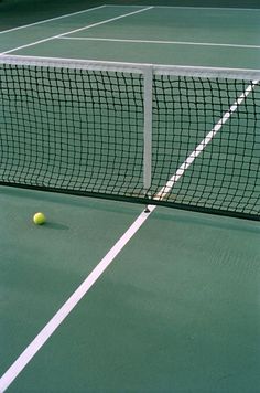 a tennis ball is sitting on the court