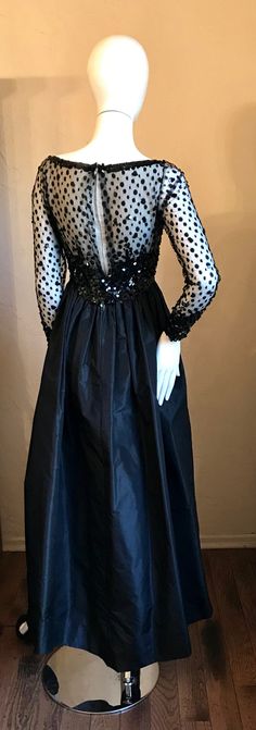 "This is the most Beautiful vintage 1960's 70's evening gown. It has a wonderful fitted bodice in an illusion black dotted tulle mesh with dangling sequins, scoop neck and heavily sequinned waist., The skirt is a crisp silk in a full gathered style with high - low hem. Shorter in front with a slightly pointed hem in back. Yes this one is Red Carpet ready for your Black tie event! Condition- Very good This is new...unworn with tag still attached. Tagged \"Alfred Bosand - New York\" and store tag Luxury Full-length Tulle Party Dress, Full Length Tulle Party Dress, Glamorous Evening Dress With Sheer Sleeves And Fitted Bodice, Floor-length Gown With Illusion Neckline For Party, Full Length Tulle Gown For Party, Party Season Evening Dress With Illusion Neckline, Party Evening Dress With Illusion Neckline And Fitted Bodice, Party Evening Dress With Sheer Back In Tulle, Cocktail Evening Dress With Sequins And Tulle