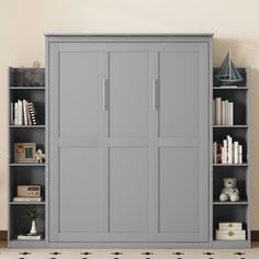 a bookcase with many books and stuffed animals on the shelves in front of it