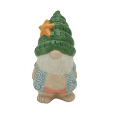 a ceramic figurine with a green hat and star on top