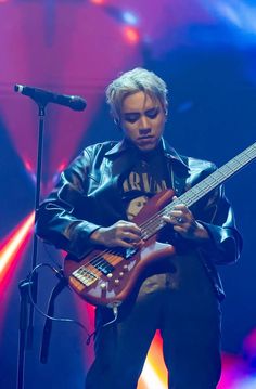 a man playing an electric guitar on stage