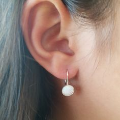 A pair of sterling silver opal leverback hoop earrings with 8 mm opal lab created stone. Dainty and delicate earrings. Perfect for everyday, simple but classic. Amazing look, no one will miss!! *Made from sterling silver. *Opal stone Size - 8mm. white opal lab created* Total length is about 0.5" . Leverback hook for safe use All my jewelry are packed in an elegant gift box Opal Earrings Dangle, White Opal Earrings, Opal Drop Earrings, Leverback Earrings, Earrings White, Opal Stone, Opal Earrings, Delicate Earrings, White Opal