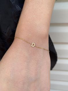 Add a personal touch with this dainty initial bracelet.DETAILS- Crafted with 14k solid gold- Chain style may vary slightly- Handmade in our New York City studioDIMENSIONS- Dimensions will vary depending on the letter- Bracelets are available in 6", 7", and 8" with 1/2" adjustable loopsPERSONALIZATIONhe letter you would like on the necklace. Please capitalize or use lower case according to your preference. VARIATIONSIf you require any variation of this style (smaller or larger nameplate, longer c Letter Bracelets, Letter Bracelet, Solid Gold Chains, Lower Case, Initial Bracelet, Custom Initials, Long Chain, Name Plate, Chain Styles