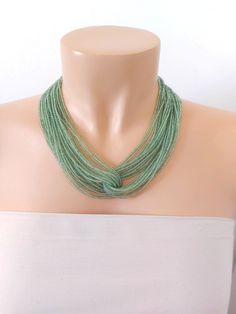 "Moss green necklace, statement beaded green necklace, seed bead necklace, bridesmaids beaded necklace, gift for women, for her It has 24 strands. Please read specifications on SIZES below. This item comes in several sizes. Kindly choose at checkout. You can use the diagram on the pictures as a reference, but keep in mind that we all have different neck and body sizes so I recommend you measure yourself to determine the right length for you. ❤ PROCESSING AND SHIPPING Most orders are made and shipped out in one business day. Please check delivery timeframes for your location on the description below.  ❤ CUSTOM ORDERS If you like this item in a different color, send me a message indicating: color, size and quantity needed. I will send you a link for a \"custom order\" and you'll be able to p Luxury Green Beaded Necklaces As Gifts, Cheap Green Beaded Chain Crystal Necklace, Cheap Green Glass Beaded Necklaces, Elegant Green Beaded Necklace With Tiny Beads, Green Beaded Chain For Wedding, Handmade Green Beaded Necklace For Wedding, Green Wedding Necklaces With Colorful Beads, Elegant Green Beaded Necklace With Colorful Beads, Elegant Green Beaded Necklace