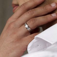 a close up of a person wearing a wedding ring