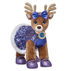 a stuffed animal wearing purple shoes and a blue dress with sequins on it