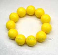 jewelry: yellow beaded bracelet - Big yellow beaded bracelet - women bracelet - gift for him - gift for her bead material: Acrylic Diameter: 20mm Shape : round Luster: High body: clean Necklace length: choose colour: yellow Packing:Beautiful Pouch If you want to order of different style. Please feel free contact me . Thank you . Matching necklace: https://www.etsy.com/listing/1456478133/big-yellow-beaded-necklace-24mm-yellow?click_key=e3a2d3a3ec69cf1654bc96ca7e2d2b2ec0985f4f%3A1456478133&click_s Yellow Beaded Stretch Bracelet With Round Beads, Yellow Beaded Stretch Bracelet, Yellow Beaded Bracelets With Large Beads For Gifts, Yellow Beaded Bracelets With Large Beads As Gift, Yellow Stretch Bracelet With Round Beads As Gift, Adjustable Yellow Stretch Bracelet With Large Beads, Yellow Stretch Bracelet Gift, Yellow Beaded Stretch Bracelet As Gift, Adjustable Yellow Stretch Bracelet With Round Beads