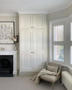 a living room filled with furniture and a fire place in front of a painting on the wall