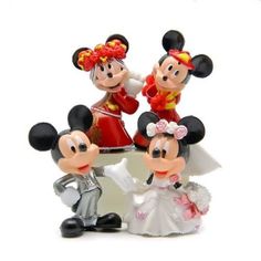 three figurines of mickey and minnie mouse on top of each other in wedding attire