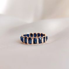 This stunning ring is set in 14k Solid Yellow Gold with Natural Blue Sapphire with utmost precision. It is an unique dainty gemstone ring for nearly every occasion and is completely hassle-free jewelry. ITEM DETAILS * Gem: Blue Sapphire * Gem Size: 3x6mm (17pcs) * Gem Shape: Rectangle * Gem weight: 5.90 carats * Gold Purity: 14KT * Gold Weight: 1.35 gram * Total Weight of the Ring: 2.53 gram The Gold purity is guaranteed and it comes with authentic 14KT gold hallmark. Since my items are handmade, they are absolutely nickel and lead free. CUSTOMIZATION: * Size Customization is available for this ring and it is available in all ring sizes. Kindly choose your ideal ring size from the drop-down. * The ring is available in 14K as well 18K Solid Gold. Kindly choose your preferred gold purity fro Elegant Faceted Sapphire Promise Ring, Faceted Sapphire Ring In Fine Jewelry Style, Elegant Sapphire Faceted Rings, Adjustable Sapphire Ring Fine Jewelry, Adjustable Sapphire Ring In Fine Jewelry Style, Elegant Sapphire Rings With Faceted Detail, Elegant Sapphire Rings With Faceted Cut, Adjustable Blue Ring With Gemstone Accents, 14k Gold Jewelry With Blue Rectangular Stone