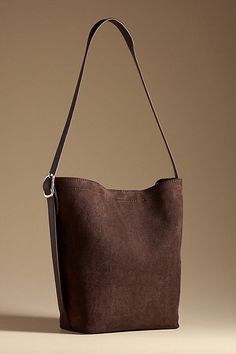 Polyester shell; polyurethane lining and strap One top-zip removable pouch Magnetic closure Imported | Faux-Suede North South Bucket Bag by Anthropologie in Brown, Women's, Polyester/Polyurethane Brown Suede Bag, Suede Tote Bag, Suede Purse, Suede Bag, Xmas List, Suede Tote, Cold Weather Fashion, North South, Christmas Wishlist