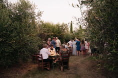 a group of people standing around a table in the middle of an outdoor dining area