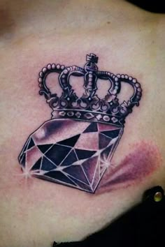 a crown tattoo on the back of a woman's upper body, with diamonds around it