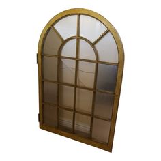 an arched window with glass panels and wood frame on the bottom half, against a white background