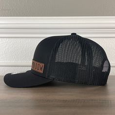 FREEDOM Flag Side Leather Patch Hat Black/Black Specifications: 🧢 Richardson original 112 trucker; adjustable for the perfect fit 🎩 60/40 cotton/polyester blend for comfort 📏 One size fits most 🏷️ Expertly laser engraved leatherette patch design 📦 Ships in 2 to 3 business days from our Orlando Studio Care Instructions: 🚫 Do not wash; spot clean only Please Note: 🌈 Colors may vary from photos based on your viewing screen. Classic Black Hat For Travel, Classic Black Travel Hat, Classic Black Snapback Hat With Logo Patch, Classic Black Adjustable Baseball Cap, Black Baseball Cap With Logo Patch, Black Adjustable Hat With Logo Patch, Black Travel Hat With Curved Brim, Black Adjustable Fitted Hat With Logo Patch, Black Travel Hat With Short Brim