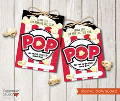 two red and black popcorn bags with the words pop on them