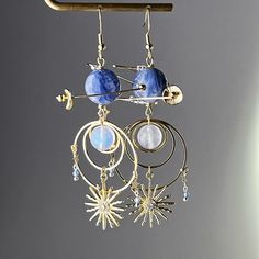 Blue Kyanite Neptune Planet Sun and Moonstone Earrings Experience the wonder of the universe with these Blue Kyanite Neptune Planet Sun and Moonstone Earrings! The intricate blue planet design combined with high quality Kyanite and blue moonstone make the perfect astrology themed accessory. Give the gift of cosmic beauty and inspire the senses with these unique earrings. As a gift shop, we offer a complimentary gift box for every order. Detail: Length of one earring - 90mm;  Size of beads - 13-1 Blue Round Earrings With Moon Charm, Celestial Blue Moonstone Jewelry, Blue Celestial Moonstone Jewelry, Celestial Blue Moon-shaped Earrings, Blue Moon Shaped Celestial Earrings, Blue Celestial Dangle Earrings, Blue Celestial Moon Earrings, Blue Celestial Round Earrings, Blue Moonstone Jewelry With Matching Earrings