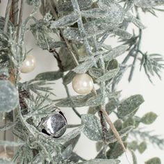 a close up of a tree with ornaments on it's branches and snow flakes