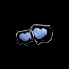 two heart shaped glasses sitting on top of each other