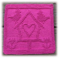 a pink crocheted placemat on a wooden surface