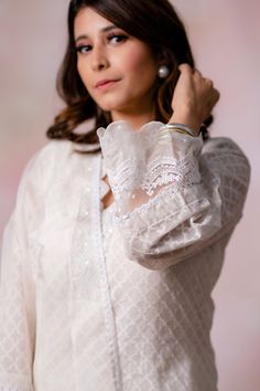 Off-white kurta with moroccan woven motifs and pearl embroidered hem. Paired with cotton pant and dupatta.
Components:3
Pattern:Woven, Embroidery
Type of Work:Moroccan, pearl
Neckline:Scallop V neck
Sleeve Type:Long sleeves
Fabric:Kurta: Woven Chanderi, Pant: Cotton, Dupatta: Organza
Color:Off White
Other Details:
Sheer panelled hem
Lace border
Sheer dupatta
Scallop border sleeve hem
Embroidered neckline
Note: Purse and outfit worn by the other model is not for sale
Occasion:Puja - Aza Fashions Elegant Festive Chikankari Embroidery Blouse, Feminine Chikankari Embroidery Sets For Wedding, White Long Sleeve Blouse With Chikankari Embroidery, Elegant Off White Sets With Chikankari Embroidery, Elegant White Designer Kurta, Classic White Kurta For Festive Occasions, Fitted Elegant Off-white Kurta, Elegant Fitted Off-white Kurta, Elegant White Sets For Eid