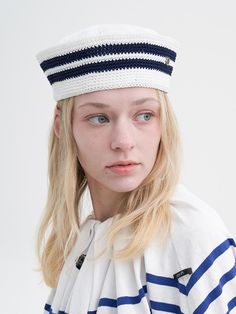 a woman with blonde hair wearing a sailor's hat