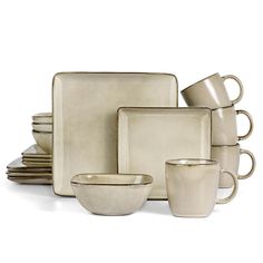 an assortment of white dishes and cups