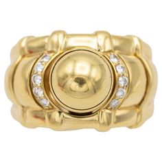 For sale is this wonderful and timeless Piaget ring. This bulky shaped ring is from the Piaget 'Tanagra' collection. This 18 karat yellow gold ring is set with ten lovely brilliant cut diamonds which combine for approximately 0.2 ct. This elegant ring is fully hallmarked and engraved with its serial number & 'Piaget 1991'. It comes without any authentic boxes or certificates. Yet we will wrap it beautifully in a small velvet ring box with a little certificate of our own. We love the elegance and sparkle of this timeless beauty. Its bombastic shape and the fact that it is a Piaget signed jewel makes it even more beautiful. - Head of ring sits approximately 10 mm off the finger. - The Ring shank is 7 mm wide. - The Ring shank is 1,4 mm thick - The ring head is 15,7 mm wide - The ring size is Piaget Ring, Velvet Ring Box, Ring Shank, Domed Ring, Elegant Ring, Yellow Gold Ring, Love Ring, Gold Jewelry Fashion, Vintage Diamond