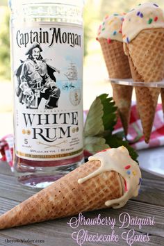 three ice cream cones with sprinkles and captain morgan rum in the background