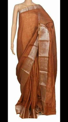 Linen sarees are always in demand.This handwoven Light Brown linen saree give you a unique style.The color is so vibrant that you are going to love it.Linen sarees are breathable,light weight and easy to drape. Fabric: Linen by linen  Thread count:100 count Saree Color: Light Brown  Occasion: Casual/Formal Saree length:5.50 mtr Blouse:Running, 1 mtr Custom Stitching: Available upon request Saree Embroidery: Available upon request Blouse Stitching: Available upon request Shipping: 7 to 10 busines Brown Chanderi Handloom Saree, Brown Handloom Chanderi Saree, Brown Raw Silk Saree For Festivals, Brown Raw Silk Saree, Brown Tussar Silk Saree With Cutdana, Traditional Linen Saree With Cutdana, Traditional Linen Saree With Zari Work, Traditional Linen Saree With Pallu, Linen Saree With Pallu