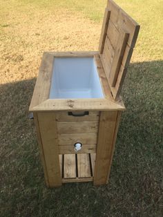 an open wooden box sitting on top of grass