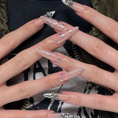 a woman's hands with clear acrylic nails