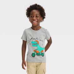 Your little one is sure to love this Dino Motorbiking Short-Sleeve Graphic T-Shirt from Cat & Jack™. Tailored in a regular fit, this short-sleeve tee is crafted from midweight jersey fabric for all-day cool comfort. Designed with a length that hits below the waist for wearing tucked in or untucked, this crewneck tee features an illustration of a motorbiking dinosaur, making it a fun pairing with different bottoms. Cat & Jack™: Kids’ clothing with an imagination of its own. Casual Gray T-shirt With Cartoon Print, Gray T-shirt With Cartoon Print And Crew Neck, Casual Short Sleeve T-shirt With Character Print, Gray Cotton T-shirt With Cartoon Print, Short Sleeve Tops With Character Print, Relaxed Fit Short Sleeve T-shirt With Character Print, Relaxed Fit Character Print T-shirt With Short Sleeves, Relaxed Fit Character Print Short Sleeve T-shirt, Playful Pre-shrunk Short Sleeve T-shirt