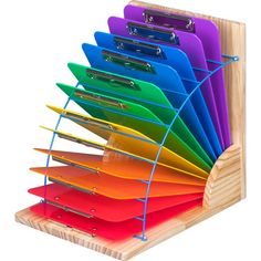 a multicolored file holder holds files and folders on a wooden stand with metal clips