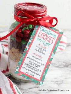 a jar filled with cookies and candy on top of a table