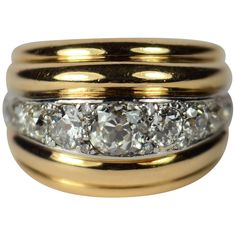 A dramatic gold and diamond dome ring in the style of Belperron, designed as five curving ridges, the central ridge set with diamonds in platinum. The 9 main diamonds are old transitional cut stones, which are interspersed with 8 smaller single-cut diamonds. The central stone is estimated to weigh 1.15 carats, with a total diamond weight of approximately 4 carats. The stones are bright and lively. The ring is marked with the eagle’s head poinçon for French manufacture, but no maker’s mark is vis Cocktail Rings Diamond, Stacked Wedding Rings, Rough Diamond Ring, Chalcedony Ring, Gold Rings Fashion, Dome Ring, Tourmaline Jewelry, Rings Diamond, Diamond Cocktail Rings