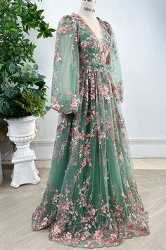 Indulge in the elegance of our Long Sleeves O Neck Pink Floral Embroidery Sage Tulle Dress. Adorned with intricate floral embroidery and crafted from delicate tulle, this dress exudes sophistication and charm. The long sleeves provide coverage while the O neck adds a touch of femininity. Perfect for special occasions and making a statement. Bust and Skirt with full lining. 100% Polyester 100% Recycled polyester lining Concealed zip at center back Imported Luxury Lavender Dress With Intricate Embroidery, Floral Lace Green Dress, Formal Dresses Long Embroidered, Luxury Floor-length Embroidered Dress For Formal Occasions, Luxury Long Dress With Floral Embroidery, Fitted Green Gown With Floral Applique, Green Wedding Gown With Floral Applique, Green Floral Applique Wedding Gown, Green Gown For Spring Banquet