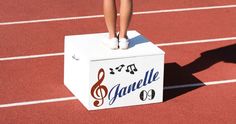 a person standing on top of a white box with musical notes painted on it's side