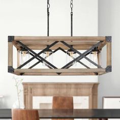 a wooden chandelier hanging over a dining room table