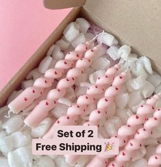 a box filled with lots of pink and white marshmallows next to a sign that says set of 2 free shipping