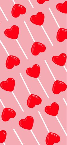 red heart shaped lollipops are on a pink and white striped background with diagonal stripes