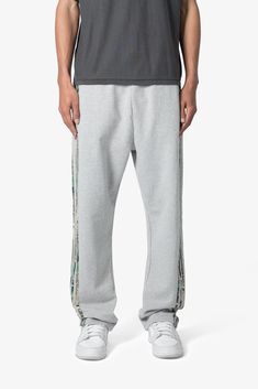 the Hunter Camo Stripe Sweatpants are designed with a relaxed fit throughout, featuring an elasticized self waist, tonal cotton drawstrings, standard hem at the leg opening, hunter camo patterned stripes at the outseam, and finished with a vintage wash. details relaxed fit 100% cotton model is 6’1, 140 lbs and wears a size medium Camouflage Cotton Long Pants, Camouflage Cotton Tapered Leg Bottoms, Camouflage Cotton Tapered Leg Pants, Cotton Camouflage Tapered Leg Pants, Camouflage Cotton Bottoms With Elastic Waistband, Camouflage Relaxed Fit Bottoms With Elastic Waistband, Camouflage Pants With Elastic Waistband For Streetwear, Casual Camouflage Cotton Sweatpants, Streetwear Cotton Pants With Elastic Side Panels