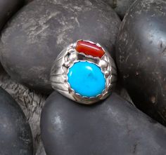 Such a stunning statement ring. This men's Native American Navajo handcrafted with traditional styling. This stunning ring features traditional heavy gauge artistry. Coral has been called the 'Garden of the Sea'. Red is considered the most sought-after color but coral. However, Mediterranean Coral is no longer being pulled from the sea due to environmental restrictions. The turquoise is another, high-grade, sought-after stone. Size: 12 Setting Measures: 1" x 3/4" Signed: S Stamped: Sterling Weig Mens Handmade Jewelry, Native American Necklace, Turquoise Jewelry Native American, Native American Rings, American Indian Jewelry, Coral Ring, Jewelry Showcases, Native American Fashion, Sterling Silver Mens