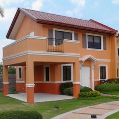 a two story house with orange paint and white trim