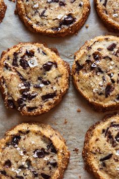 chocolate chip cookies sitting on top of a baking sheet