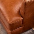 a brown leather couch sitting on top of a carpet