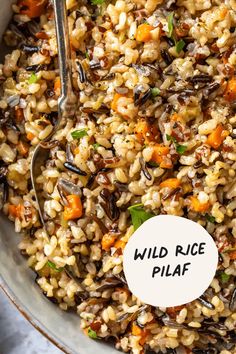 a bowl filled with rice and vegetables on top of a table