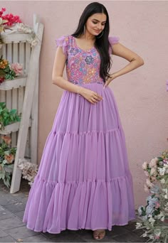 Readymade Faux Georgette Tiered Dress in Light Purple This attire is Enhanced with Resham and Sequins Work. Crafted in V Neck and Angle Sleeve Its Length is 56 inches Do note: 1.)Accessories shown in the image are for presentation purposes only and length may vary upto 2 inches. 2.)Slight variation in actual color vs. image is possible. Hands Designs For Long Frocks, Long Frock Designs For Women, Frocks Designs For Women, Long Frock Models, Creative Dresses, Angle Sleeve, Frock Designs For Women, Dress Designs For Stitching, Frock Models